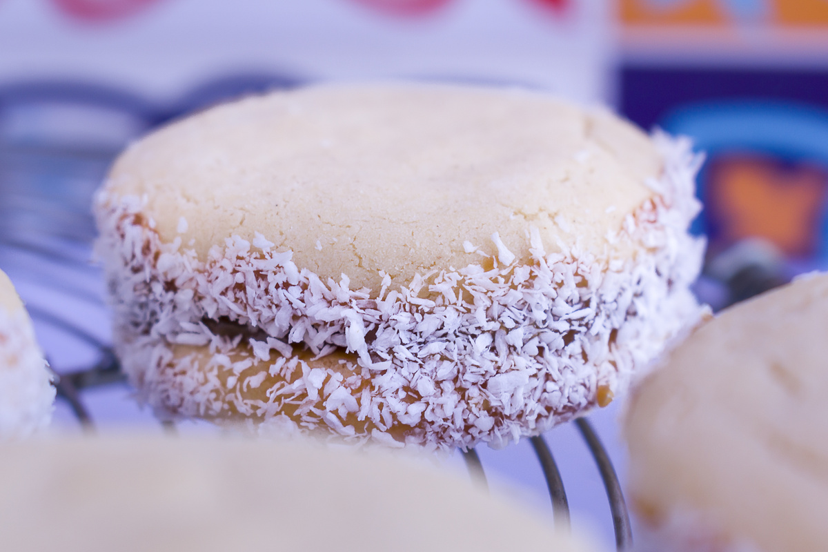 Selective focus on Cornstarch cookies alfajor filled with dulce de Leche and grated coconut.